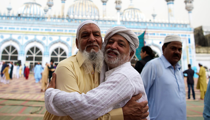 Two men warmly embrace each other following Eid prayers in this AFP photo by Aamir Qureshi.
