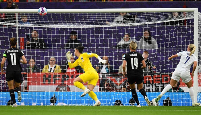 England´s striker Beth Mead (R) watches her shot loop over the goalkeeper for the opening goal of the UEFA Women´s Euro 2022 Group A football match between England and Austria at Old Trafford in Manchester, north-west England on July 6, 2022. No use as moving pictures or quasi-video streaming. Photos must therefore be posted with an interval of at least 20 seconds.  Photo: Afp