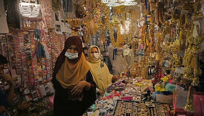 Women buy jewelry at market area during shopping ahead of Eid in Rawalpindi, Pakistan, on May 6, 2021. — AFP