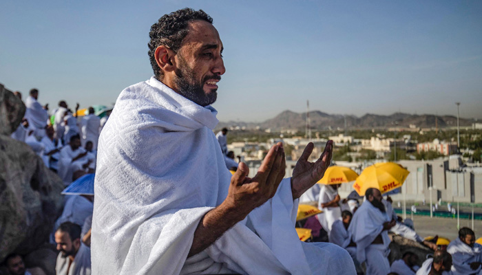 A pilgrim prays atop Mount Arafat, also known as Jabal al-Rahma (Mount of Mercy), southeast of the holy city of Makkah, during the climax of the Hajj pilgrimage, early on July 8, 2022. — AFP