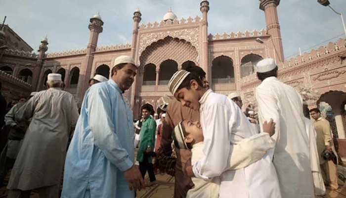 An image of people embracing each other on the festive occasion of Eid - AFP