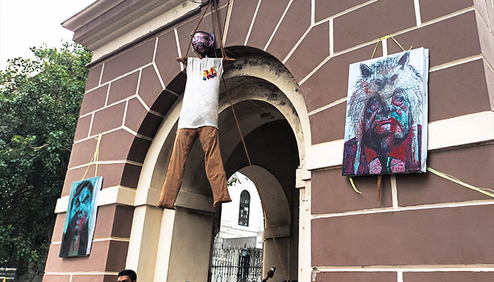 Activists stand under an effigy of Sri Lankas President Gotabaya Rajapaksa, hanging from a clock tower near his official residence, in Colombo on July 10, 2022. — AFP