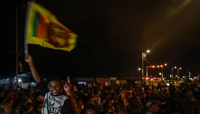 Demonstrators take part in a celebration as Sri Lanka´s protest movement reached its 100th day at the Galle face protest area near Presidential secretariat in Colombo on July 17, 2022. -AFP