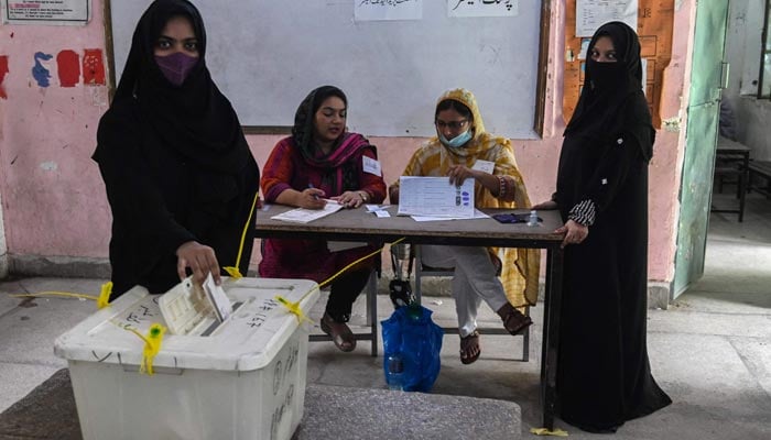 Voters cast their ballot at a polling station during the by-election in Punjab province assembly seat in Lahore on July 17, 2022. — AFP/File