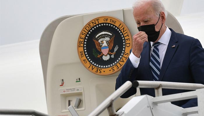 In this file photo taken on April 14, 2022 US President Joe Biden touches his face mask as he steps off Air Force One upon arrival at Hagerstown Regional Airport in Hagerstown, Maryland. — AFP