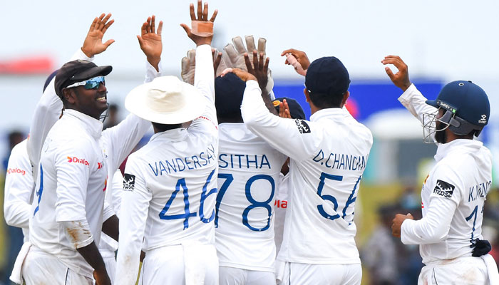 Sri Lanka’s Angelo Mathews (L) celebrates with teammates after the dismissal of a Pakistani batsman during the final day of the second cricket Test at the Galle International Cricket Stadium on July 28. Photo: AFP