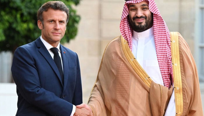 Macron warmly greeted the kingdoms de-facto ruler ahead of a dinner, defying objections from activists. Photo: AFP