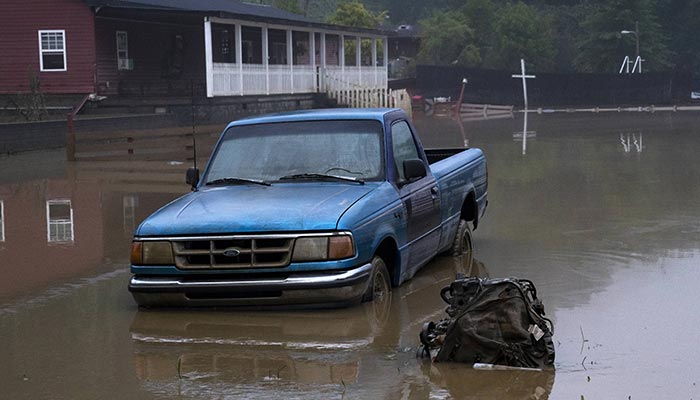 Receded water levels from the North Fork of the Kentucky River surround a truck in downtown Jackson in Jackson, Kentucky, on July 30, 2022. — AFP