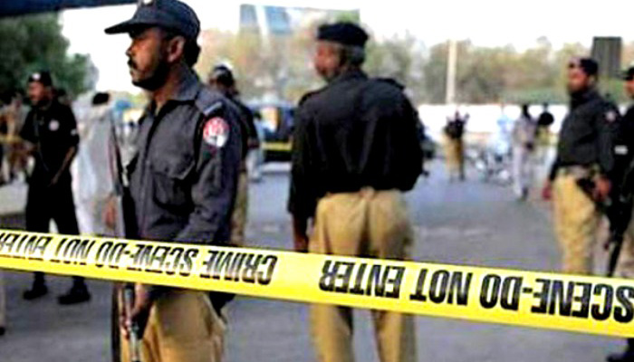 A file photo of policemen securing a crime scene.