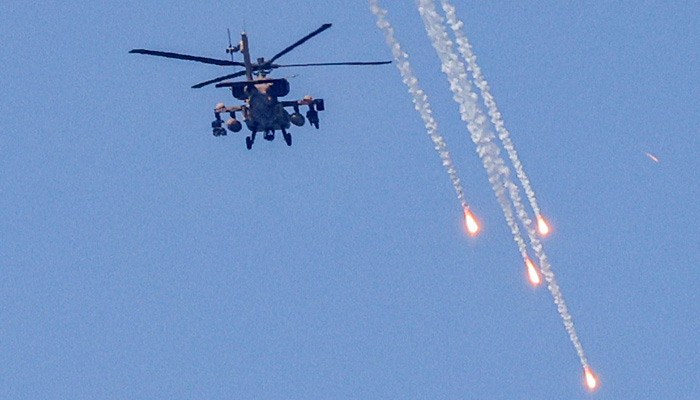 An Israeli military AH-64 Apache attack helicopter fires flares while flying over Ashkelon in southern Israel on August 6, 2022. -AFP