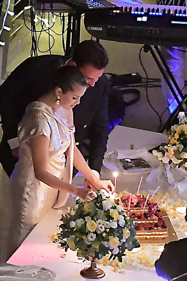 Selena Gomez cutting her two birthday cakes