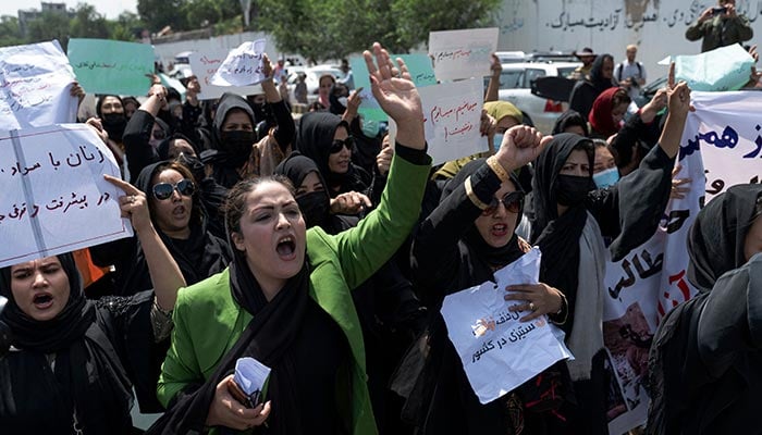 Afghan women hold placards as they march and shout slogans Bread, work, freedom during a womens rights protest in Kabul on August 13, 2022. Taliban fighters beat women protesters and fired into the air on Saturday as they violently dispersed a rare rally in the Afghan capital, days ahead of the first anniversary of the groups return to power. — AFP/File