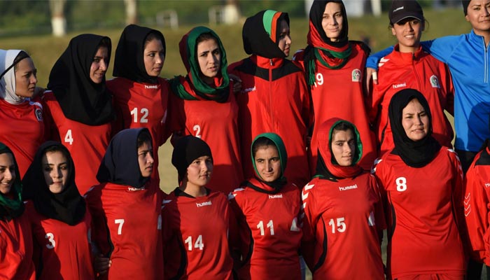 Afghan women football players group up for a photograph during a practice session at a sports complex in Islamabad. — AFP/File