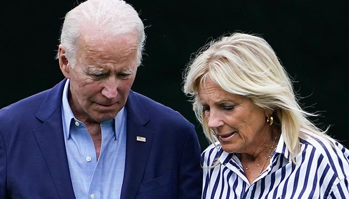US President Joe Biden (L) with his wife Jill Biden walks on the South Lawn upon returning to the White House in Washington, DC. — AFP/File