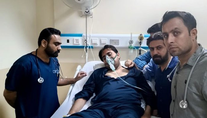 PTI leader Shahbaz Gill seen lying on a hospitals bed with an oxygen mask on. — Twitter