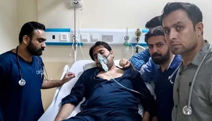 PTI leader Shahbaz Gill seen lying on a hospitals bed with an oxygen mask on. — Twitter