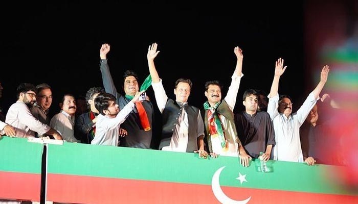 PTI chief Imran Khan stands alongside party members at the rally in Islamabads F-9 Park. — PTI/Instagram
