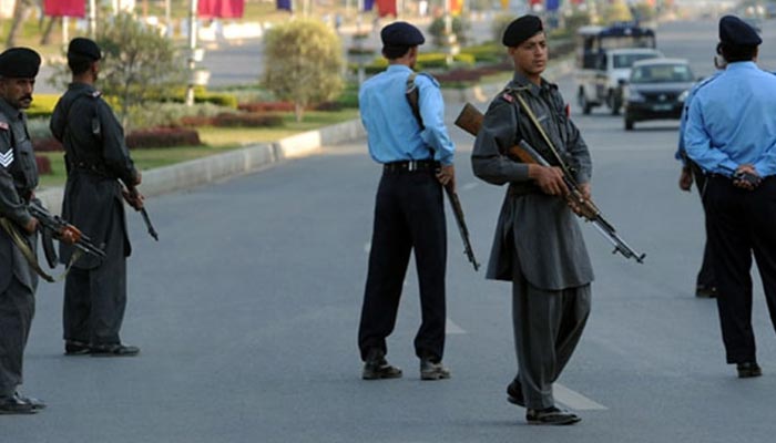 Islamabad Police personnel guard a VIP movement in the federal capital. — AFP/File