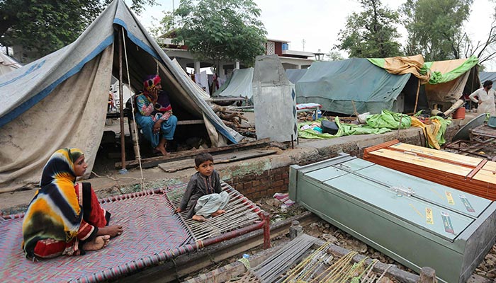 Residents take shelter at a makeshift camp after their homes were damaged by flooding following heavy monsoon rainfall in the flood affected area of Rajanpur district in Punjab. — AFP