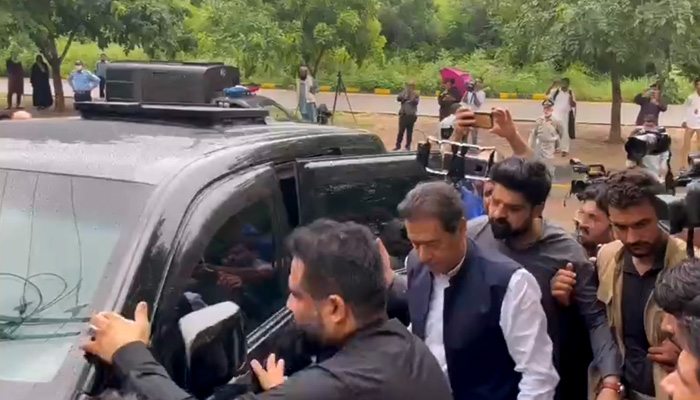 Former prime minister Imran Khan reaches court to appear in a terrorism case filed for threatening police officials and a judge. Screengrab PTI Twitter