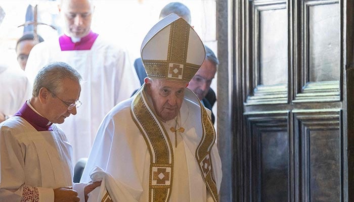Pope Francis crosses the Holy Door during the Rite of Opening at the Basilica of Santa Maria di Collemaggio in L´Aquila, on August 28, 2022, during a one-day pastoral visit to the 2009 earthquake-struck Abruzzo capital. — AFP