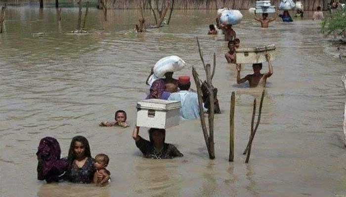 People are wading through rainwater in Sindh. Photo: file