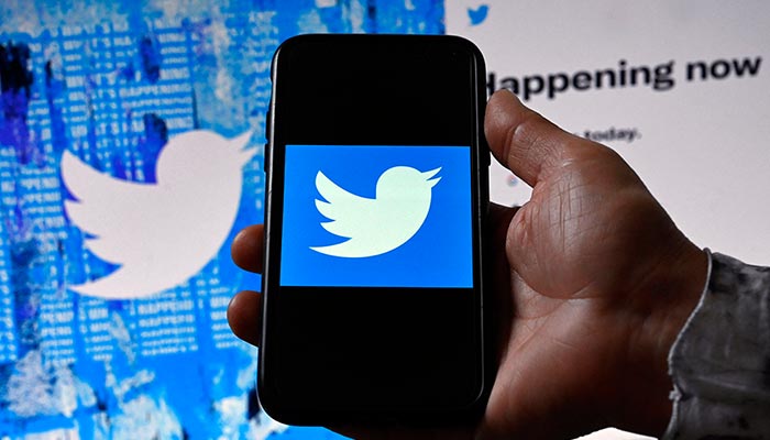 In this file photo illustration taken on April 26, 2022, a phone screen displays the Twitter logo on a Twitter page background in Washington, DC. — AFP/File