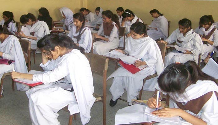 Female students appear for annual exams. — File