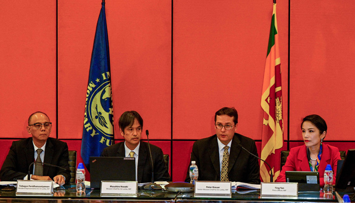 Senior Mission Chief for Sri Lanka of the International Monetary Fund (IMF) Peter Breuer (2R) speaks during a press conference next to Mission Chief for Sri Lanka (IMF) Masahiro Nozaki (2L) in Colombo on September 1, 2022. -AFP