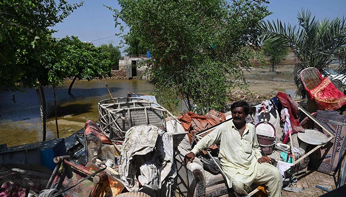 Mureed Hussain sits with the dowry furniture of his daughter Nousheen, which was damaged by flood waters at his house in Fazilpur, Rajanpur district of Punjab province on September 3, 2022. — AFP/File