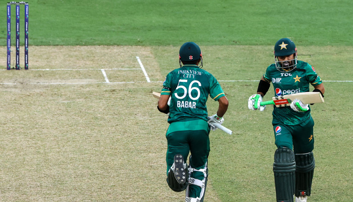 Pakistans captain Babar Azam (L) and teammate Mohammad Rizwan take a run during the Asia Cup Twenty20 international cricket Group A match between India and Pakistan at the Dubai International Cricket Stadium in Dubai on August 28, 2022. -AFP