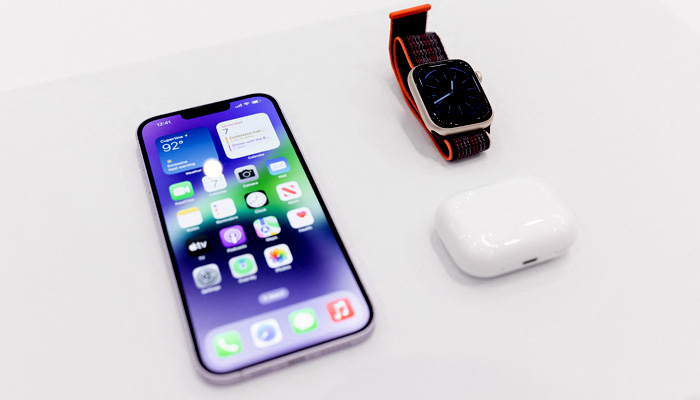 The new iPhone 14 is displayed alongside the new Apple Watch 8 Series and new AirPod Pros during a launch event for new products at Apple Park in Cupertino, California, on September 7, 2022. Apple unveiled several new products including a new iPhone 14 and 14 Pro, three Apple watches, and new AirPod Pros during the event. -AFP