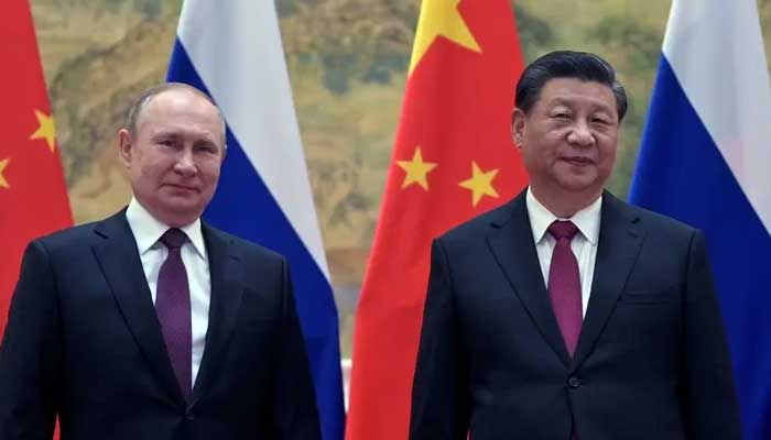 Russian President Vladimir Putin (L) and Chinese President Xi Jinping pose during their meeting in Beijing, February 4, 2022. — AFP