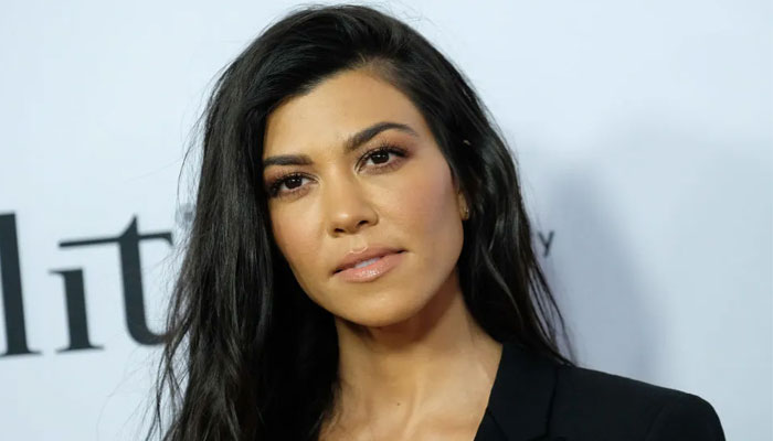 Kourtney Kardashian puts pregnancy rumours to rest while bashing fan