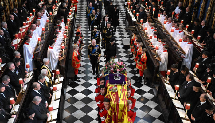 King Charles III (L), Camilla, Princess Anne, Prince Andrew, Prince Edward, Sophie, Prince William, Prince George, Catherine, Prince Harry, Meghan Markle, walk behind the coffin of Queen Elizabeth II as they leave Westminster Abbey- AFP