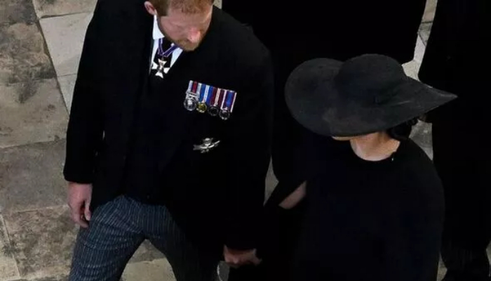Prince Harry and Meghan Markle appeared to stay close to each other for comfort at the Queens funeral