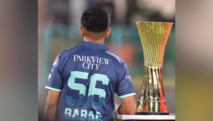Babar Azam, captain of Pakistans cricket team, stands alongside the trophy of upcoming series with England. — Photo by reporter
