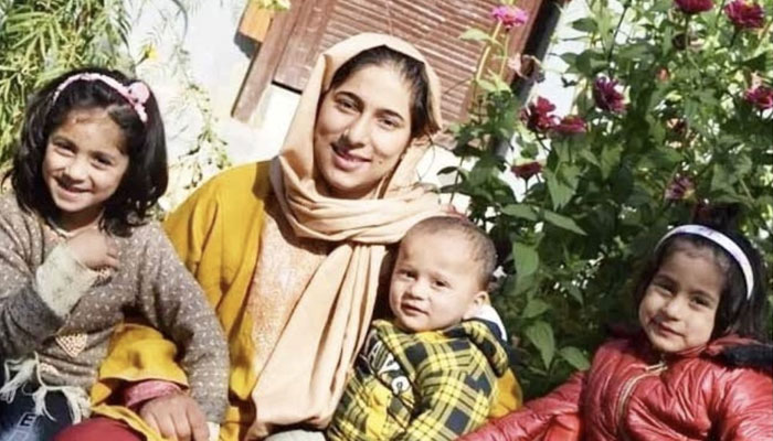 Picture of the viral Kashmiri woman, who topped in class X exams, with her children. — Twitter