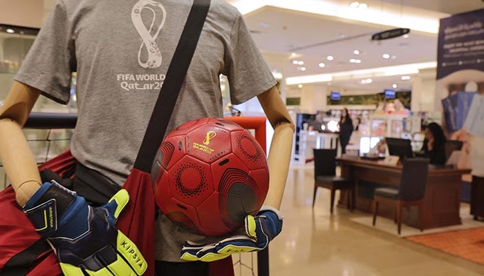 (R to L) Qatari businessmen Ashraf Abu Issa and brother Nabil Abu Issa pose for a picture with officially-licensed Qatar 2022 FIFA World Cup merchandise in their shop in Qatar´s capital Doha on September 13, 2022. — AFP/File