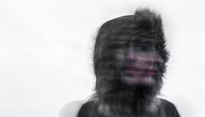 Creepy-looking art where a person faces front and sideways at the same time. — Unsplash