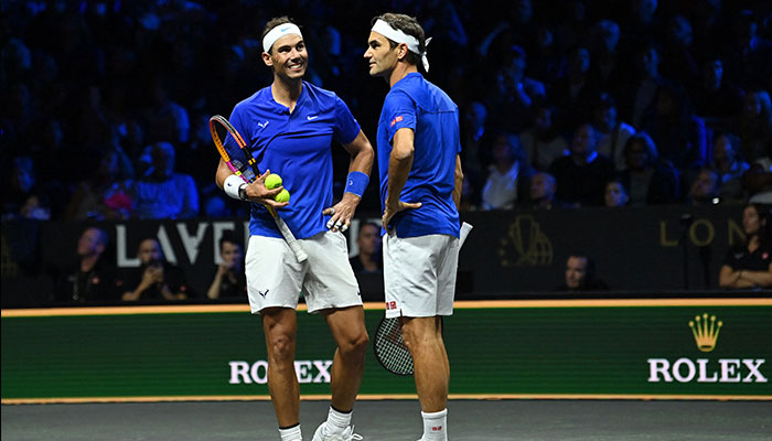 Switzerland´s Roger Federer (R) communicates with Spain´s Rafael Nadal (L) of Team Europe playing against USA´s Jack Sock and USA´s Frances Tiafoe of Team World during their 2022 Laver Cup men´s doubles tennis match at the O2 Arena in London on September 23, 2022. — AFP