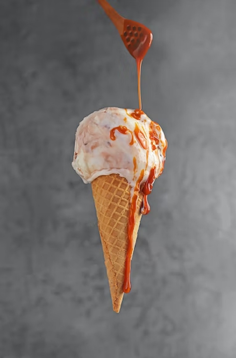 Caramel sauce drops on ice cream. — Unsplash