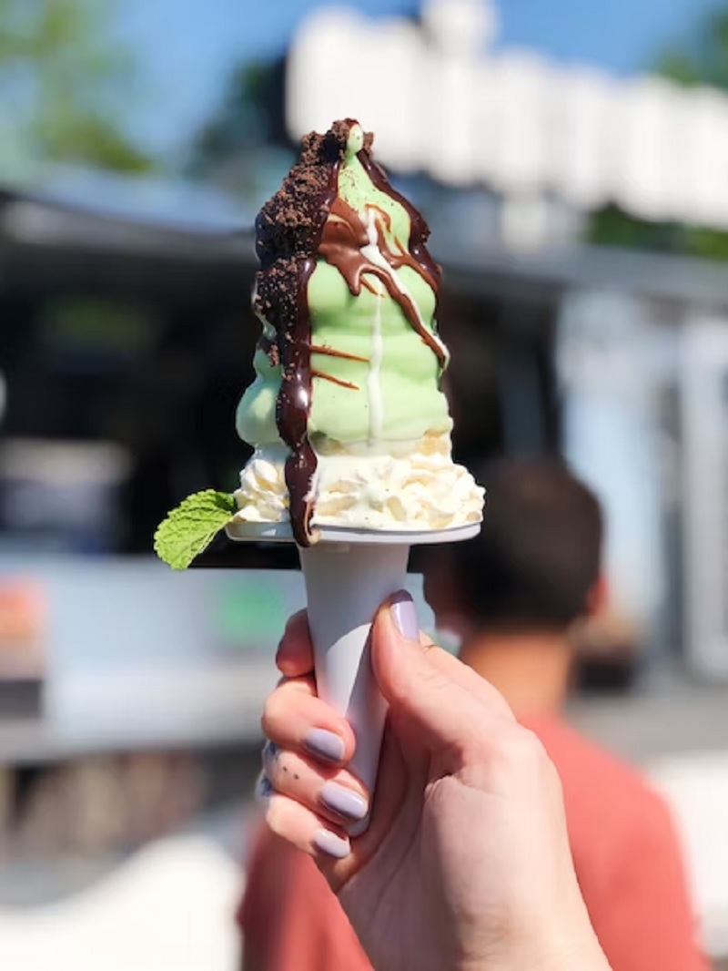 Woman holding mint chocolate ice cream.— Unsplash