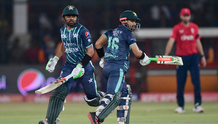 Pakistani batters Babar Azam and Mohammad Rizwan take a run during a T20I match against England. —AFP/File