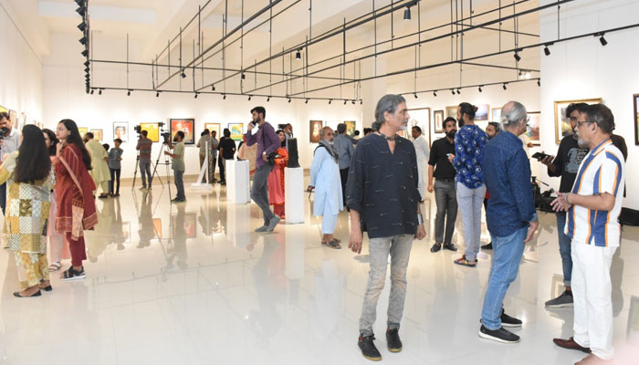 People are showing interest at the inauguration of the three-day exhibition for flood victims. AKC