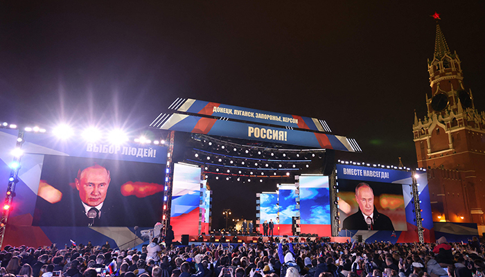 Russian President Vladimir Putin is seen on a screen set at Red Square as he addresses a rally and a concert marking the annexation of four regions of Ukraine Russian troops occupy - Lugansk, Donetsk, Kherson and Zaporizhzhia, in central Moscow on September 30, 2022. — AFP