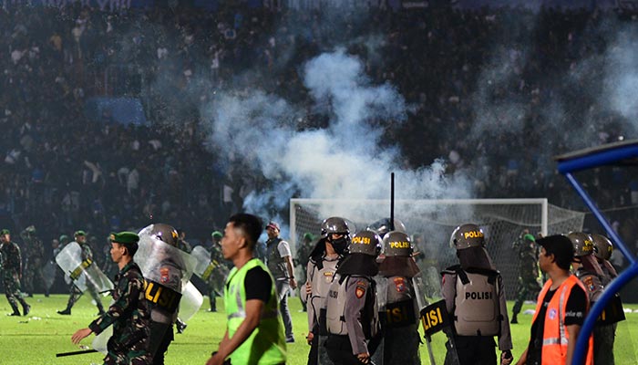 This picture taken on October 1, 2022 shows tear gas let off by police amongst people crowded in the stands after a football match between Arema FC and Persebaya at the Kanjuruhan stadium in Malang, East Java. — AFP/File