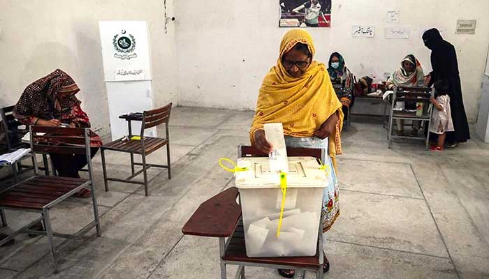 A voter casts her vote during an election. — AFP