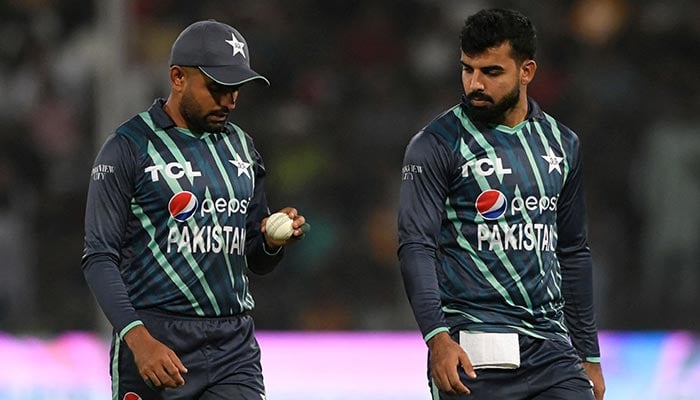 Pakistans captain Babar Azam (L) looks at the ball next to his teammate Shadab Khan during the seventh Twenty20 international cricket match between Pakistan and England at the Gaddafi Cricket Stadium in Lahore on October 2, 2022. — AFP/File