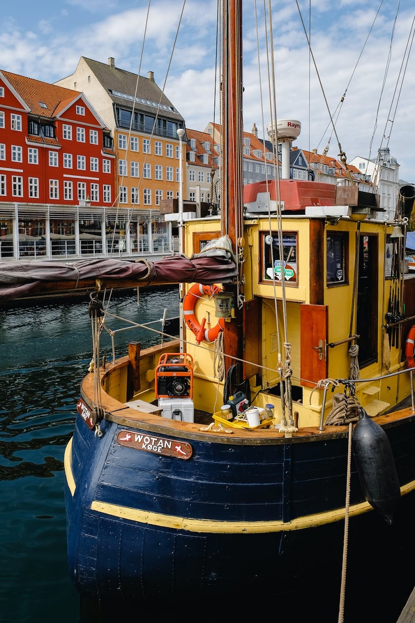 Yellow and Blue Boat Floating in a Canal in Copenhagen, Denmark. —Pexel
